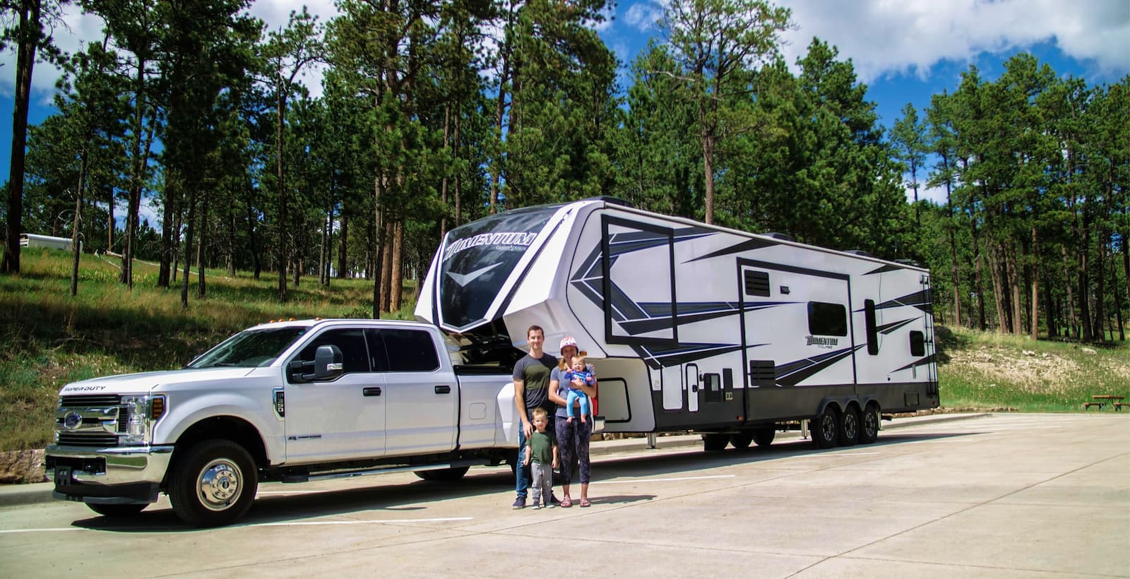 Family parked in front of a fifth wheel