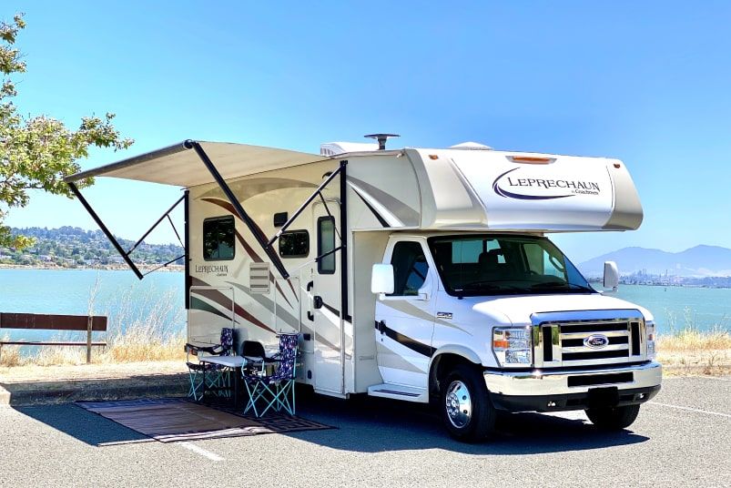 Class C parked next to a lake